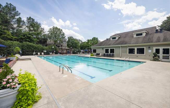 the swimming pool with the apartment building in the background