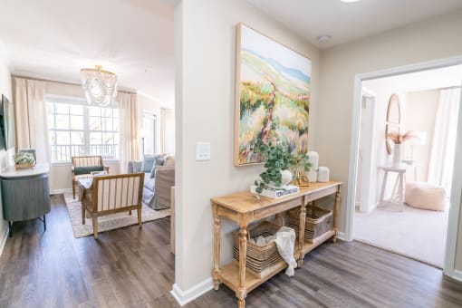 a living room with a table and a painting on the wall