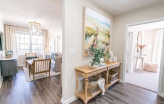 a living room with a table and a painting on the wall