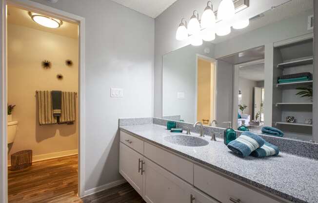 an empty bathroom with a large mirror and a sink