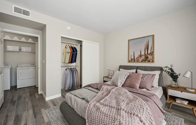 a bedroom with a bed and a closet with a laundry room