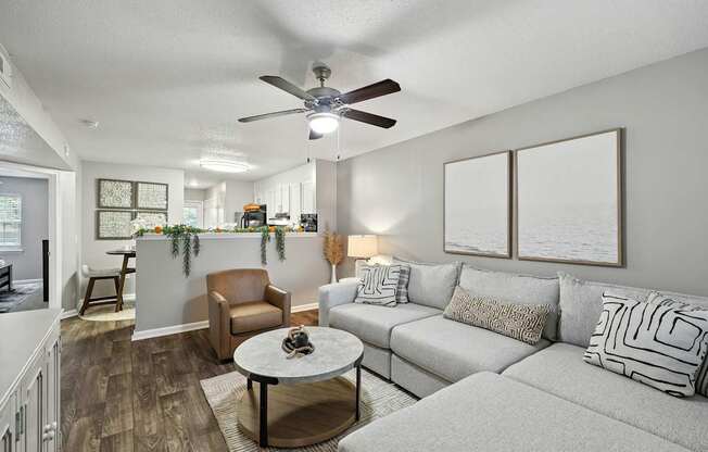 A living room with a grey couch and a coffee table.