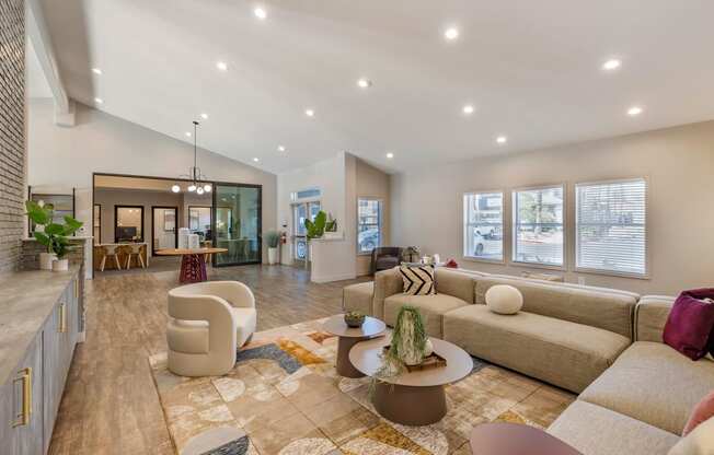 a living room with a couch and a table at Paisley and Pointe Apartments, Las Vegas