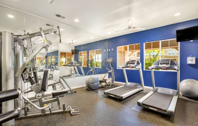 a gym with cardio equipment and weights at Montessa at Whitney Ranch