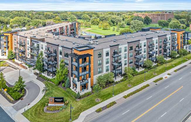 A large apartment complex with a green lawn in front.