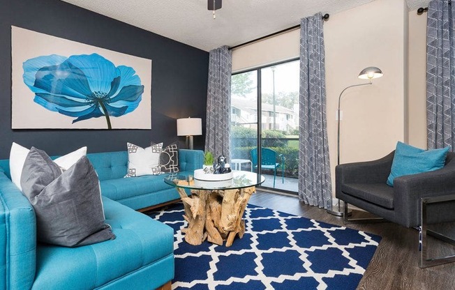 a living room with blue couches and a blue rug