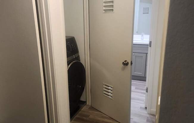 A white door is open to a hallway.