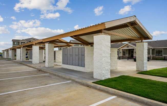 a covered parking lot with houses in the background