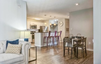 an open living room and kitchen with a dining room table and chairs