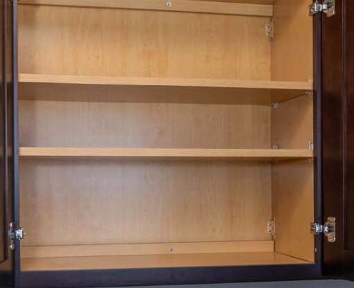 an empty shelf in a wooden cupboard