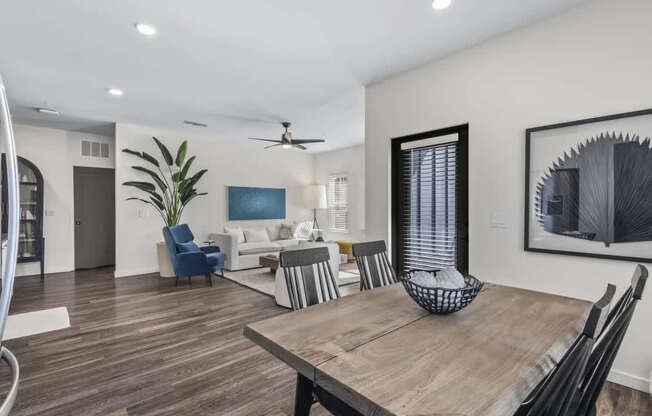 A modern dining room with a wooden table and chairs.