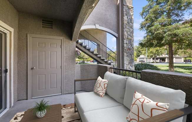 a patio with a couch and a table and a door