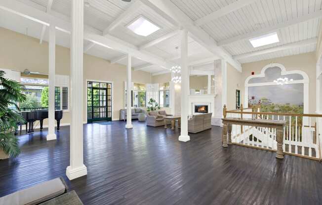 a large living room with a fireplace and a staircase at Willow Tree Apartments, Torrance, CA