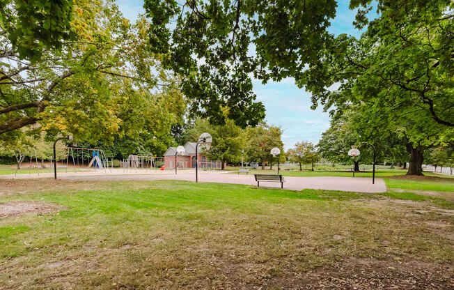 A park with a playground and a picnic table.