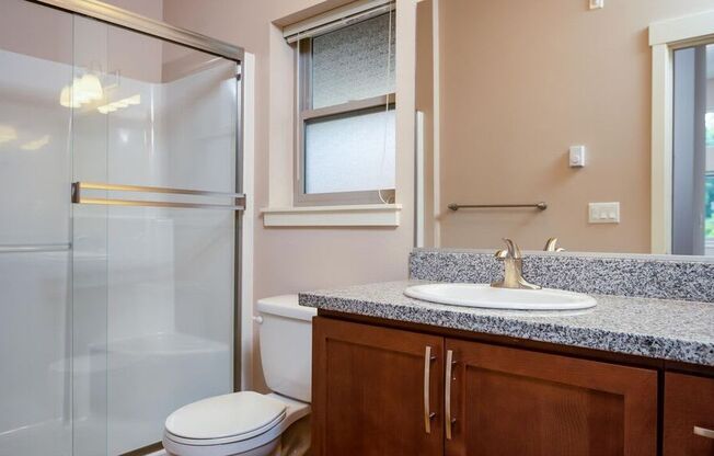 a bathroom with a sink toilet and shower