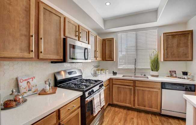 A kitchen with wooden cabinets and a black stove top.