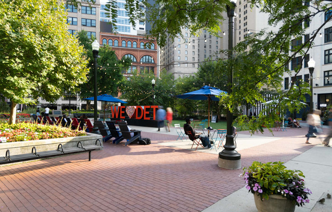 a park with benches and trees in a city