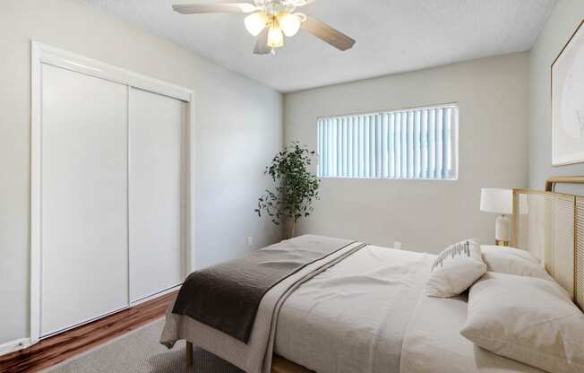 a bedroom with a large bed and a ceiling fan