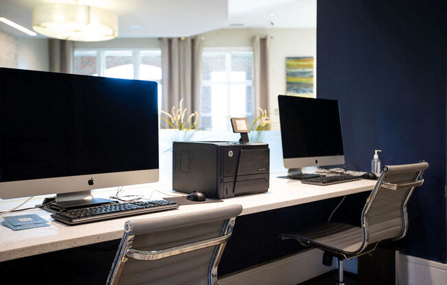 an office with two computer monitors on a desk