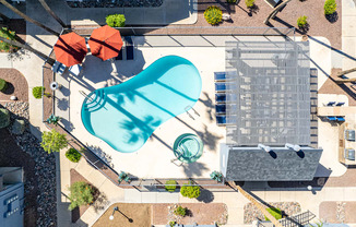 an aerial view of a building with a blue pool in the middle of it