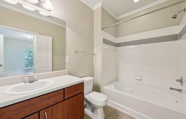 A white bathroom with a sink, toilet, and bathtub.