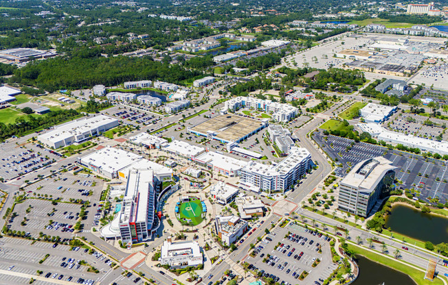 An aerial view of a large city with a mix of buildings and green spaces.at Icon One, Daytona Beach, Florida