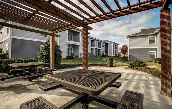 outdoor seating area under pergola with landscaping