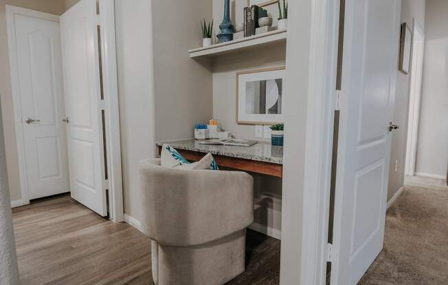 A room with a vanity table and a chair.