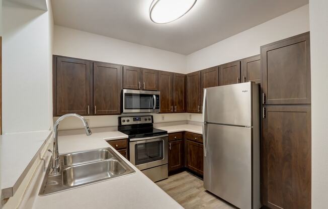 a kitchen with stainless steel appliances and wooden cabinets