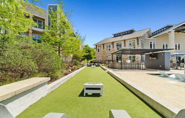 A modern building with a green lawn in front.