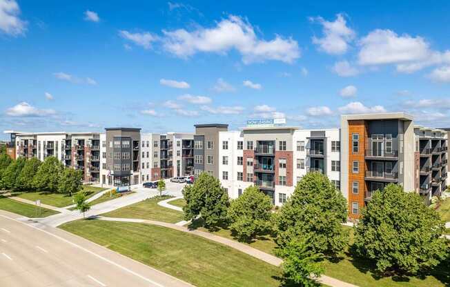 A row of modern apartment buildings with a clear blue sky above.