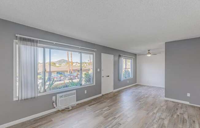 an empty living room with a large window