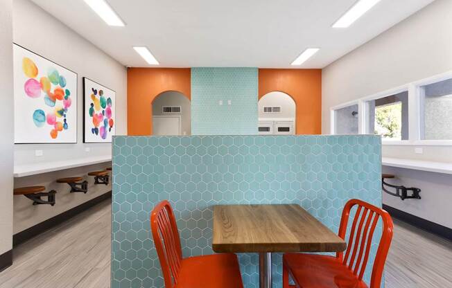 A dining area with a table and chairs.