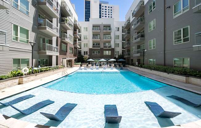 A swimming pool in the middle of apartment buildings.