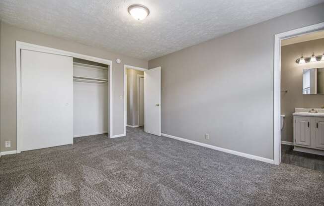 Omaha, NE Maple Ridge Apartments. A bedroom with a bathroom and a closet