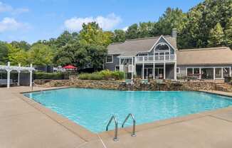 luxury swimming pool with a waterfall at The Berkshires at Vinings apartments