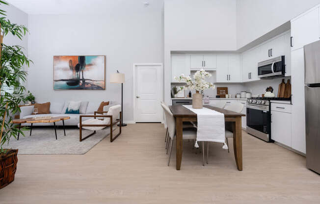 A modern kitchen with a dining table and chairs.