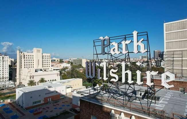 A large sign that says Parkshire is in front of a city skyline.