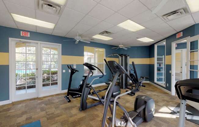 A gym with treadmills, exercise bikes and other equipment.