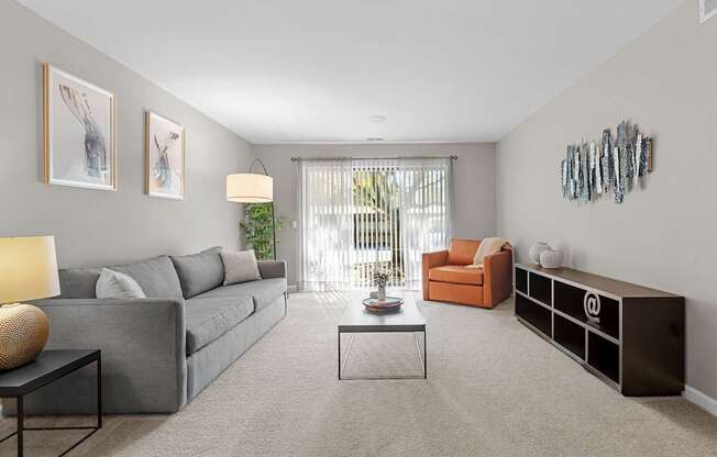 Spacious Living Room with Sliding Glass Door at Lakeside Village Apartments Clinton Township MI