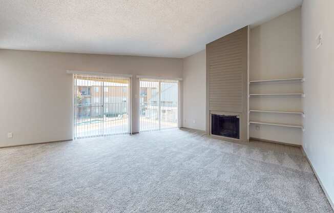 A spacious living room with a fireplace and sliding glass doors.