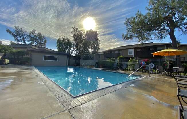 a swimming pool with the sun shining over it