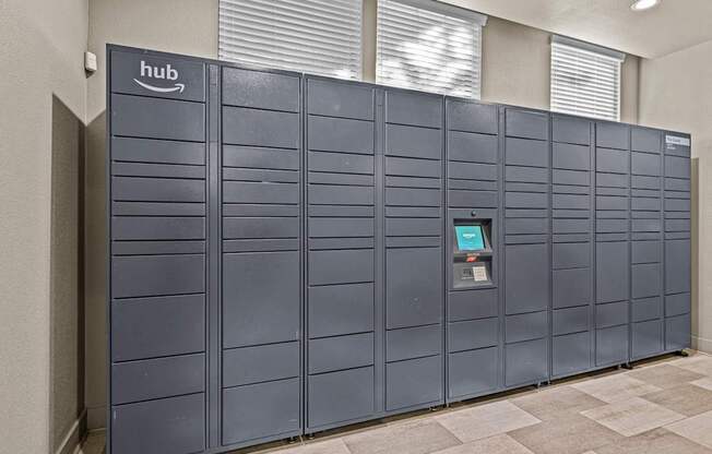 A row of Amazon hub vending machines are lined up against a wall.