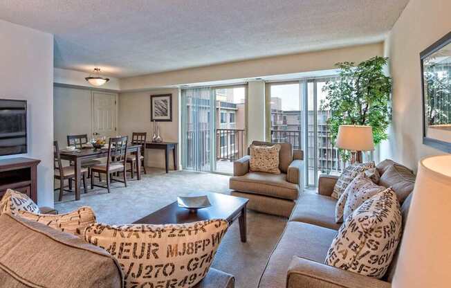 A living room with a couch, chairs, and a coffee table.