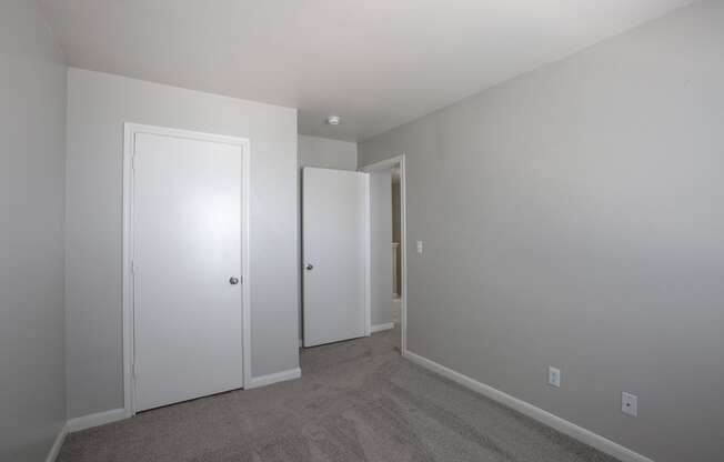 Bedroom with Carpet and Closet at The Bluffs at Tierra Contenta Apartments in Santa Fe New Mexico