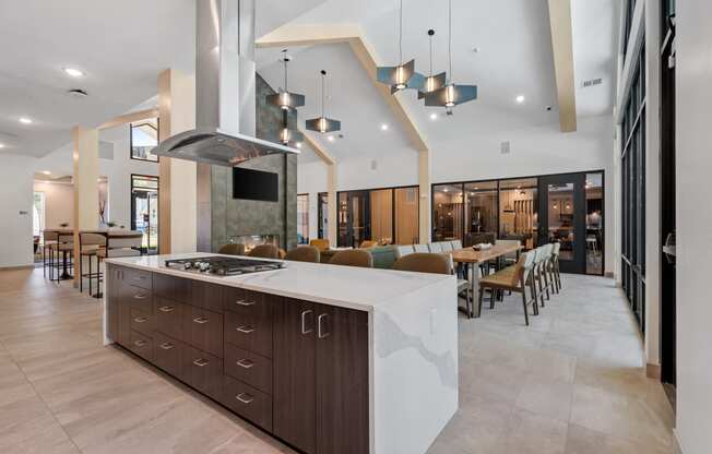 a kitchen with an island and a dining room in the background at The Lodge at Overland, Rochester, Minnesota