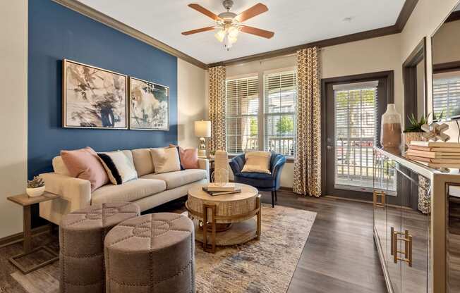 a living room with blue and white walls and a balcony