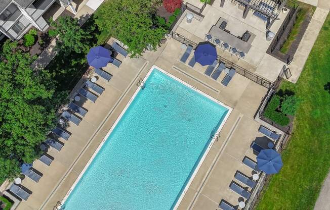 a swimming pool with umbrellas and chairs around it