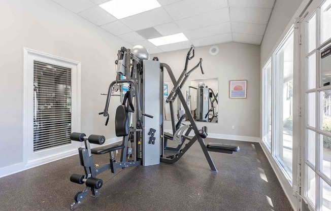 A well-equipped gym with a variety of machines and weights.