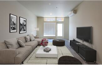 a living room filled with furniture and a flat screen tv